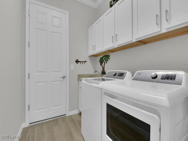 15904 Talon Ter, Punta Gorda, FL 33982 - laundry area featuring washer and clothes dryer, wood tiled floors, cabinet space, and ornamental molding