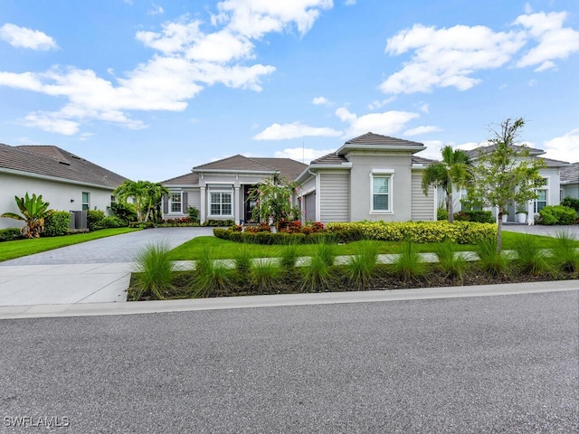 15904 Talon Ter, Punta Gorda, FL 33982 - view of front facade featuring driveway, a garage, and stucco siding