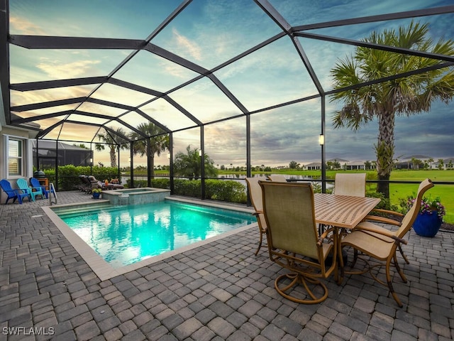 15904 Talon Ter, Punta Gorda, FL 33982 - view of pool featuring a patio area, a pool with connected hot tub, glass enclosure, and outdoor dining area