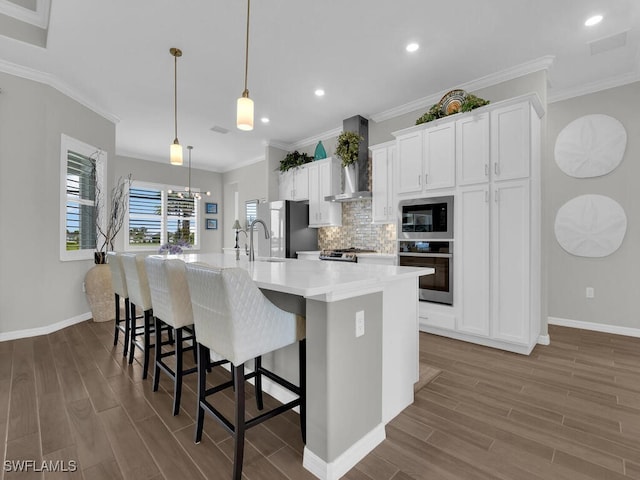 15904 Talon Ter, Punta Gorda, FL 33982 - kitchen with stainless steel appliances, wall chimney range hood, dark wood-style floors, decorative backsplash, and recessed lighting