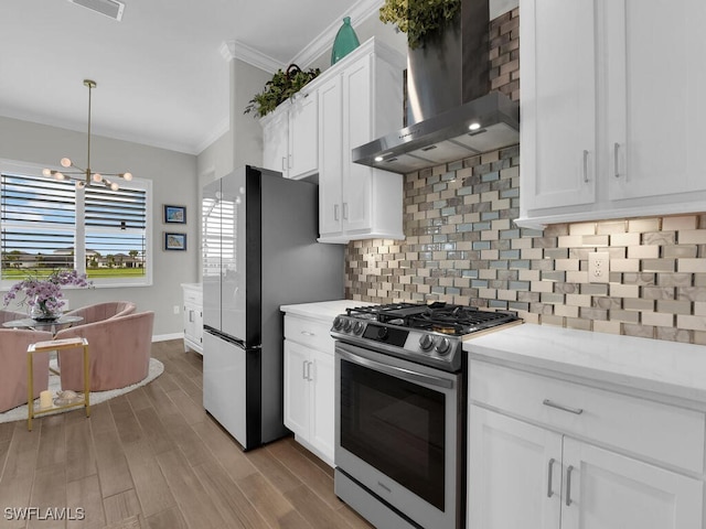 15904 Talon Ter, Punta Gorda, FL 33982 - kitchen featuring wall chimney range hood, stainless steel appliances, ornamental molding, tasteful backsplash, and white cabinetry