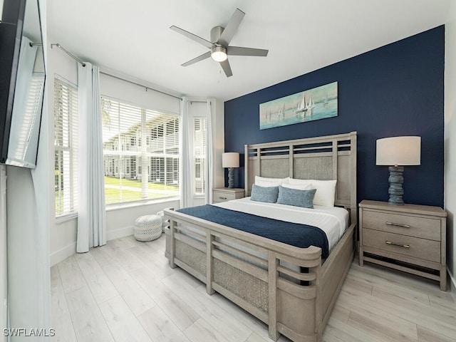 7970 Mahogany Run Ln Unit 216, Naples, FL 34113 - bedroom with light wood-type flooring and a ceiling fan
