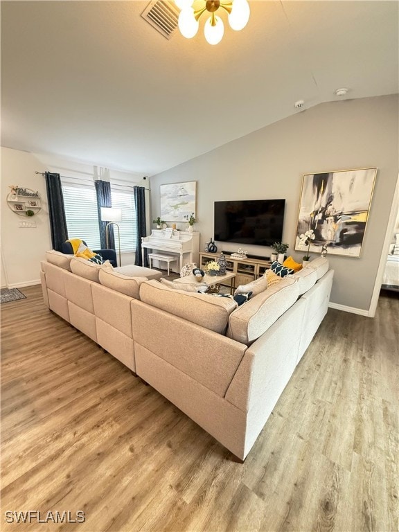 3006 Base Ct, Labelle, FL 33935 - living room with wood finished floors, vaulted ceiling, and a chandelier