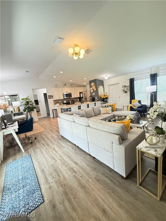 3006 Base Ct, Labelle, FL 33935 - living room with lofted ceiling, light wood finished floors, and recessed lighting