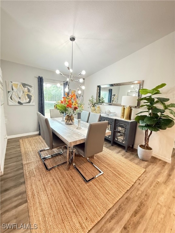 3006 Base Ct, Labelle, FL 33935 - dining area featuring light wood-style flooring, a chandelier, and lofted ceiling