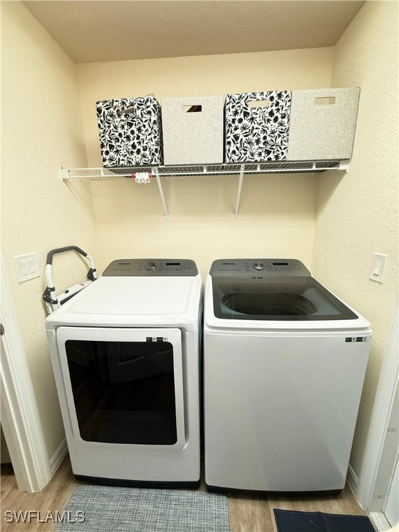 3006 Base Ct, Labelle, FL 33935 - laundry area featuring wood finished floors and washer and clothes dryer