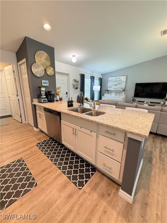3006 Base Ct, Labelle, FL 33935 - kitchen with dishwasher, white cabinetry, open floor plan, light wood-type flooring, and recessed lighting