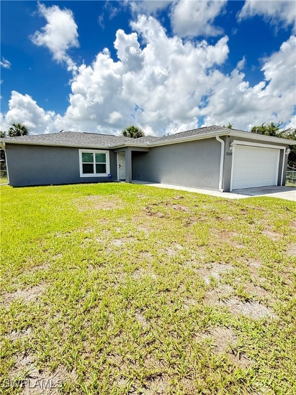 3006 Base Ct, Labelle, FL 33935 - ranch-style house featuring an attached garage, stucco siding, a front yard, and concrete driveway