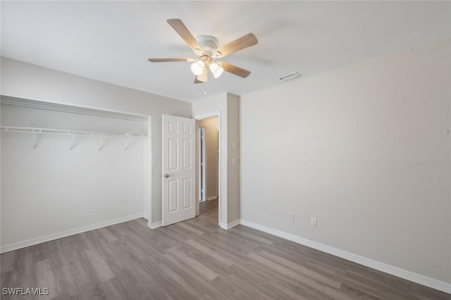 27924 Quinn St, Bonita Springs, FL 34135 - unfurnished bedroom with wood finished floors, a closet, and a ceiling fan