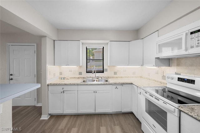 27924 Quinn St, Bonita Springs, FL 34135 - kitchen with white appliances, light wood finished floors, decorative backsplash, white cabinets, and light stone countertops