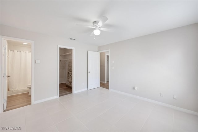 27924 Quinn St, Bonita Springs, FL 34135 - unfurnished bedroom with ensuite bath, a walk in closet, ceiling fan, and a closet