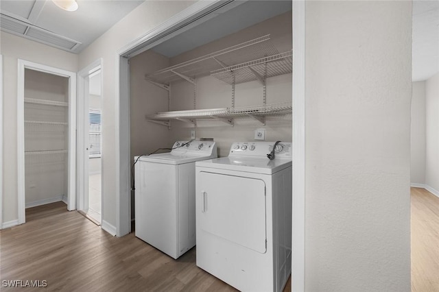 27924 Quinn St, Bonita Springs, FL 34135 - laundry area with washing machine and dryer and wood finished floors
