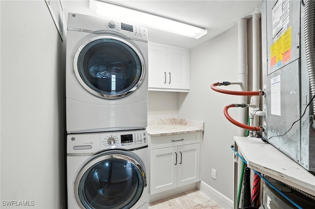 1100 S Collier Blvd Unit 723, Marco Island, FL 34145 - laundry area with stacked washer / dryer, cabinet space, and heating unit