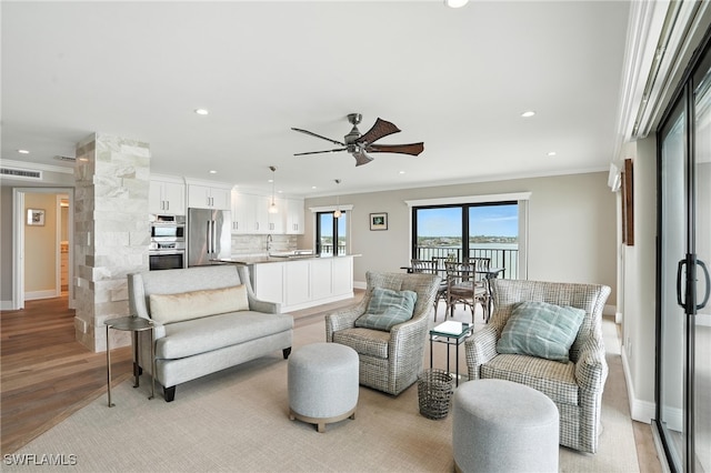 1100 S Collier Blvd Unit 723, Marco Island, FL 34145 - living room with crown molding, ceiling fan, recessed lighting, and light wood finished floors