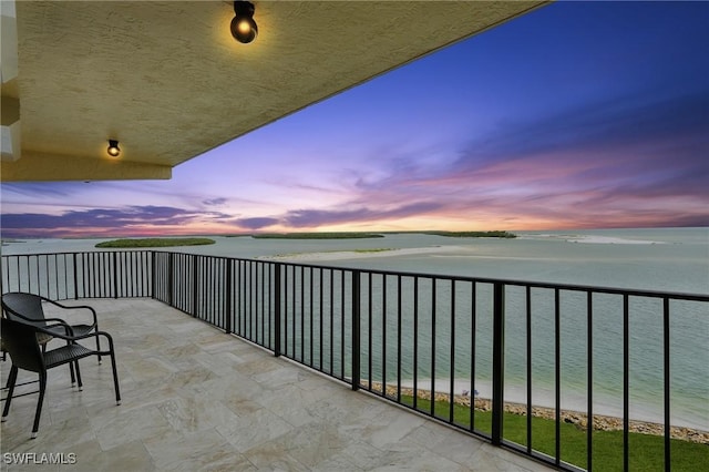 1100 S Collier Blvd Unit 723, Marco Island, FL 34145 - balcony at dusk featuring a water view