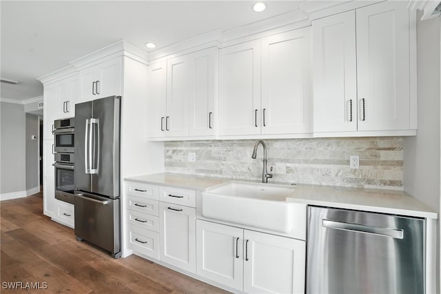 1100 S Collier Blvd Unit 723, Marco Island, FL 34145 - kitchen featuring stainless steel appliances, recessed lighting, light countertops, dark wood-style flooring, and white cabinetry