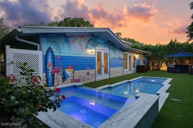 1129 8th Ter N, Naples, FL 34102 - back of house with an in-ground hot tub, french doors, a yard, an outdoor hangout area, and an outdoor pool