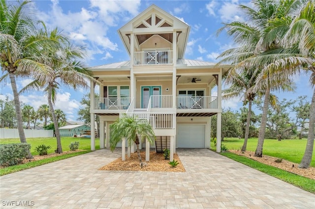 830 San Carlos Dr, Fort Myers Beach, FL 33931 - beach home with a front lawn, a porch, an attached garage, and decorative driveway