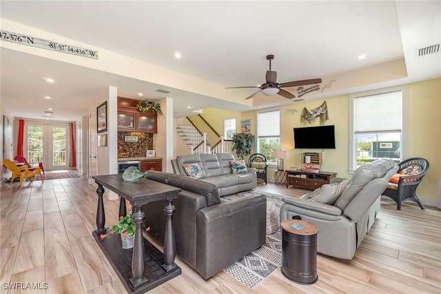 830 San Carlos Dr, Fort Myers Beach, FL 33931 - living area with healthy amount of natural light, stairs, recessed lighting, light wood-style flooring, and a ceiling fan