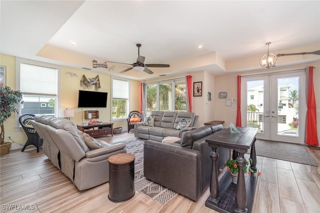 830 San Carlos Dr, Fort Myers Beach, FL 33931 - living area with a tray ceiling, ceiling fan, light wood-type flooring, and plenty of natural light