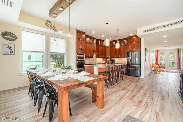 830 San Carlos Dr, Fort Myers Beach, FL 33931 - dining space with light wood-style flooring, recessed lighting, and french doors