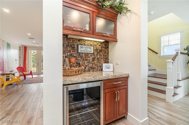 830 San Carlos Dr, Fort Myers Beach, FL 33931 - indoor dry bar with beverage cooler, light wood-style flooring, backsplash, stairway, and healthy amount of natural light
