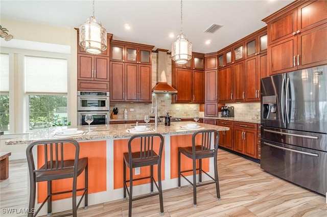 830 San Carlos Dr, Fort Myers Beach, FL 33931 - kitchen with stainless steel appliances, wall chimney exhaust hood, decorative backsplash, decorative light fixtures, and recessed lighting