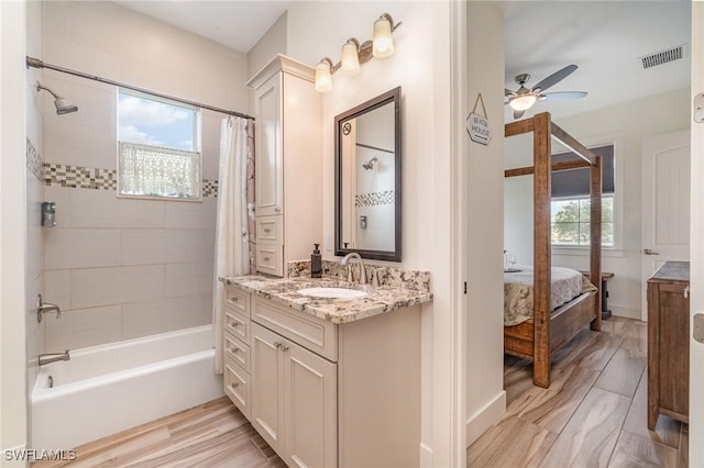 830 San Carlos Dr, Fort Myers Beach, FL 33931 - ensuite bathroom featuring shower / bathtub combination with curtain, vanity, and ceiling fan