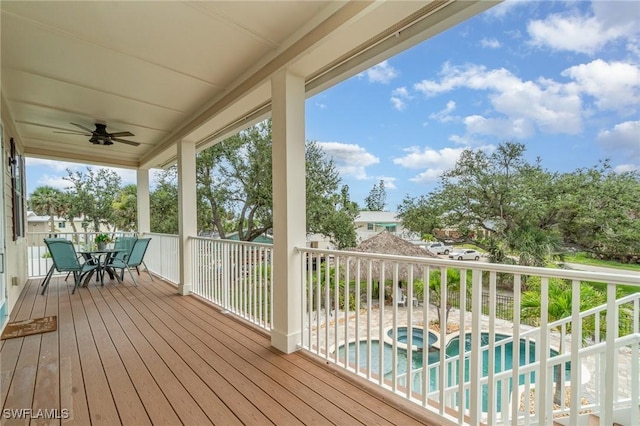 830 San Carlos Dr, Fort Myers Beach, FL 33931 - wooden deck with a ceiling fan, a pool with connected hot tub, and outdoor dining area