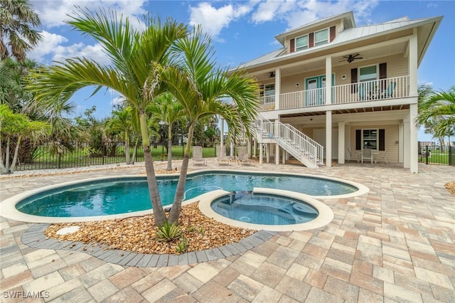 830 San Carlos Dr, Fort Myers Beach, FL 33931 - view of swimming pool featuring a ceiling fan, stairs, a pool with connected hot tub, and a patio area