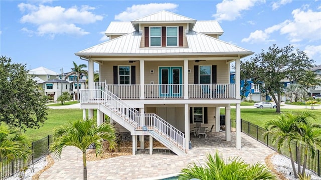 830 San Carlos Dr, Fort Myers Beach, FL 33931 - view of front of property with covered porch, stairway, a metal roof, and ceiling fan