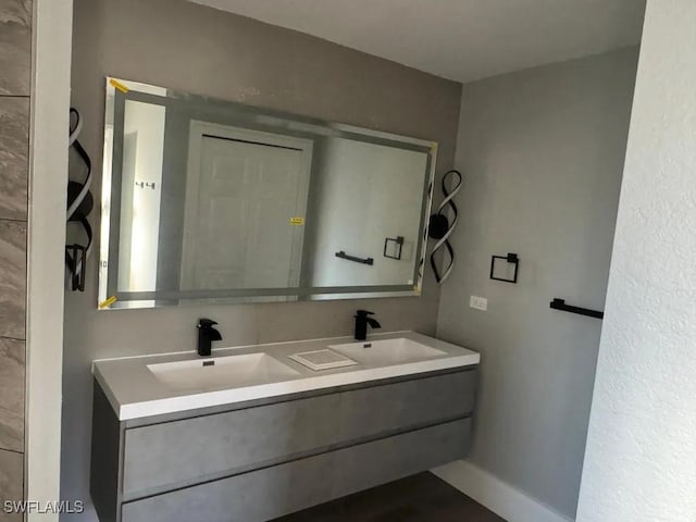 1614 SW 27th St, Cape Coral, FL 33914 - bathroom with double vanity and baseboards