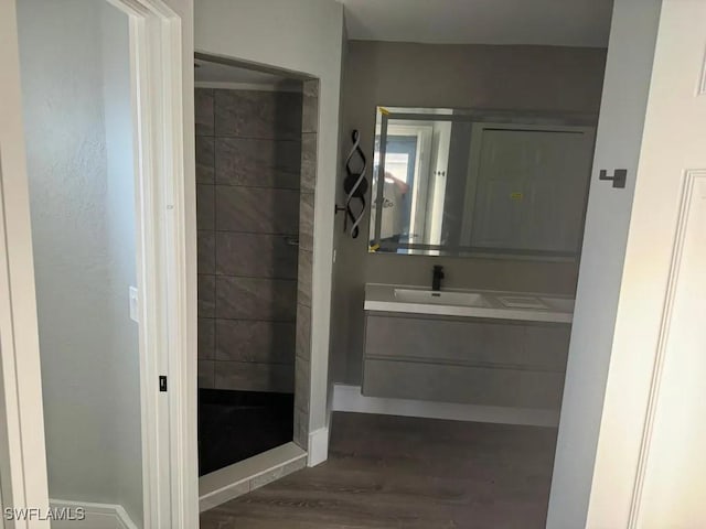 1614 SW 27th St, Cape Coral, FL 33914 - full bathroom with wood finished floors, vanity, and tiled shower