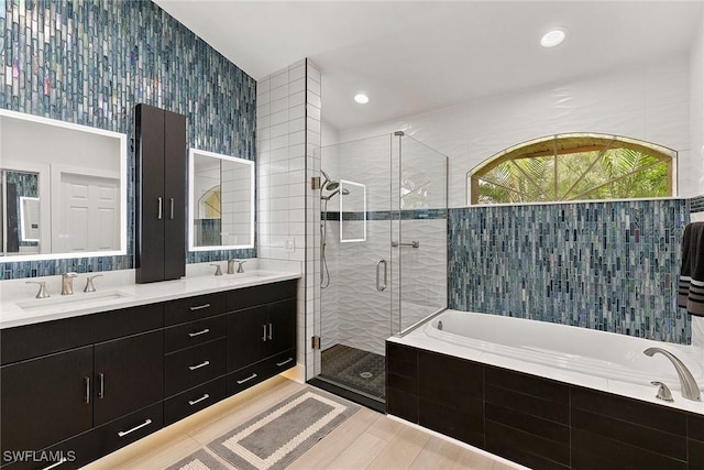 2322 River Reach Dr, Naples, FL 34104 - bathroom featuring a bath, a shower stall, double vanity, wood finished floors, and recessed lighting