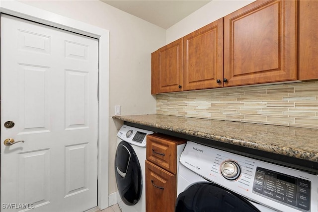 2322 River Reach Dr, Naples, FL 34104 - laundry room featuring washer / clothes dryer and cabinet space