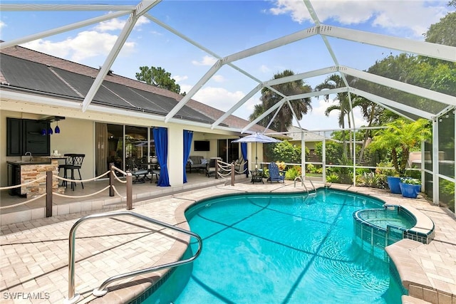 2322 River Reach Dr, Naples, FL 34104 - view of swimming pool with a patio, a pool with connected hot tub, glass enclosure, and an outdoor hangout area