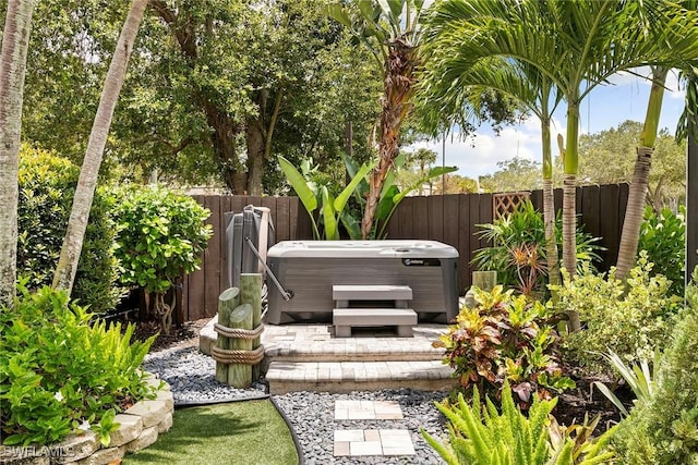 2322 River Reach Dr, Naples, FL 34104 - fenced backyard featuring a hot tub and a patio area