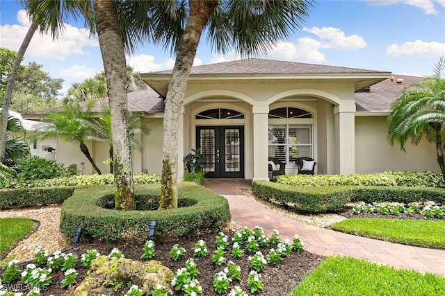 2322 River Reach Dr, Naples, FL 34104 - property entrance with french doors, stucco siding, and roof with shingles