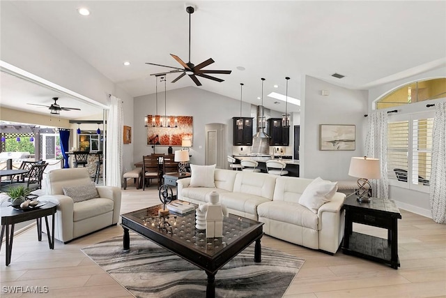 2322 River Reach Dr, Naples, FL 34104 - living area with ceiling fan, vaulted ceiling, light wood-type flooring, recessed lighting, and arched walkways