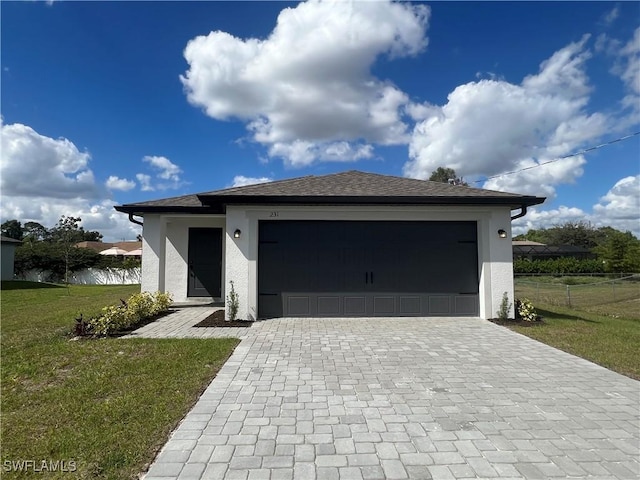 726 Goldrock Rd, Lehigh Acres, FL 33974 - view of front facade featuring decorative driveway, stucco siding, and an attached garage