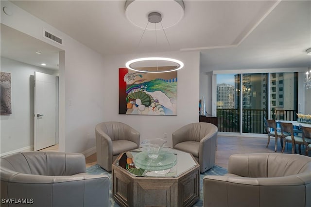 7515 Pelican Bay Blvd Unit 8A, Naples, FL 34108 - living area featuring a chandelier and wood finished floors