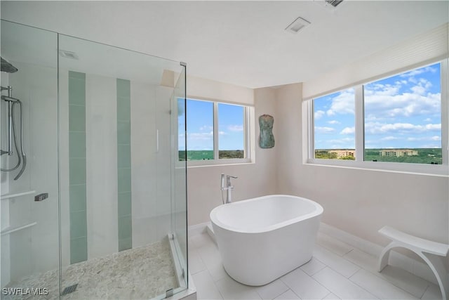 7515 Pelican Bay Blvd Unit 8A, Naples, FL 34108 - full bathroom with a shower stall, a freestanding bath, and tile patterned flooring