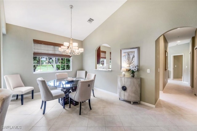 24320 Sandpiper Isle Way Unit 202, Bonita Springs, FL 34134 - dining space featuring arched walkways, light tile patterned floors, a chandelier, and high vaulted ceiling