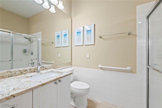 28864 Yellow Fin Trl, Bonita Springs, FL 34135 - full bathroom with an enclosed shower, vanity, a wainscoted wall, tile patterned floors, and tile walls