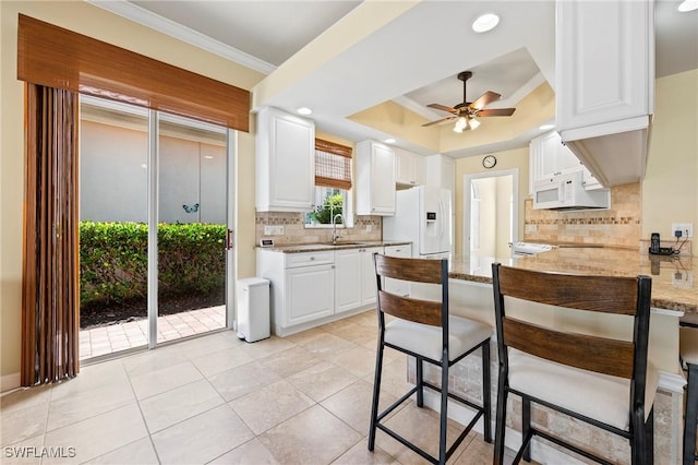 28864 Yellow Fin Trl, Bonita Springs, FL 34135 - kitchen featuring white appliances, a ceiling fan, ornamental molding, a peninsula, and light tile patterned floors