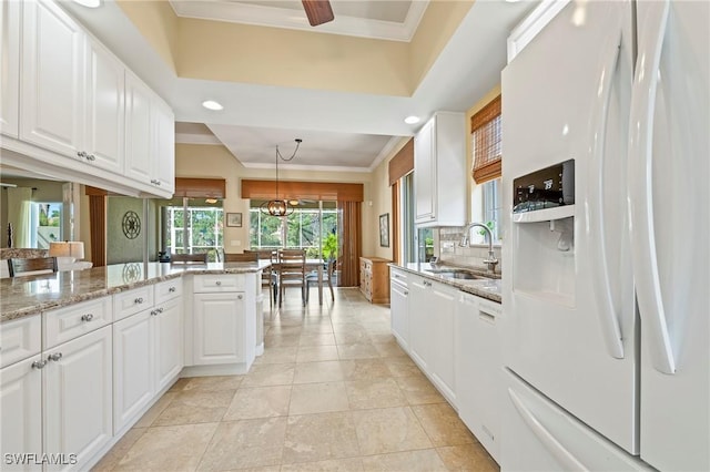 28864 Yellow Fin Trl, Bonita Springs, FL 34135 - kitchen with white appliances, white cabinets, crown molding, light stone countertops, and recessed lighting