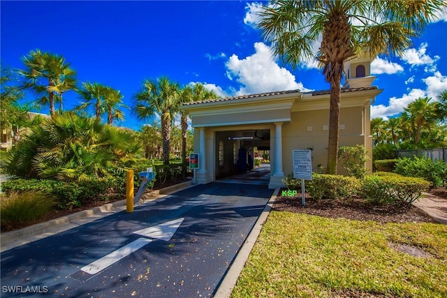 28864 Yellow Fin Trl, Bonita Springs, FL 34135 - view of front facade featuring asphalt driveway, stucco siding, and a tiled roof