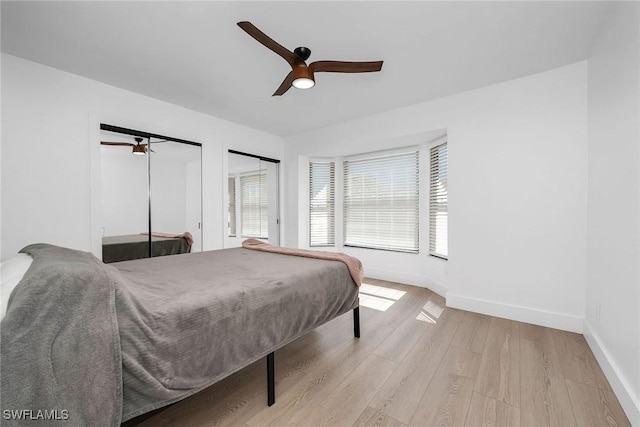 221 Saint James Way, Naples, FL 34104 - bedroom featuring light wood-style flooring, multiple closets, and ceiling fan