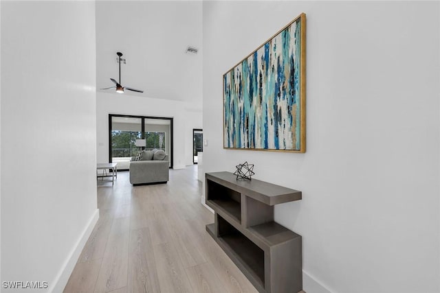 221 Saint James Way, Naples, FL 34104 - hallway featuring a towering ceiling and light wood-type flooring