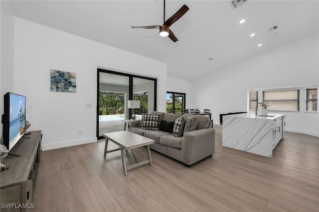 221 Saint James Way, Naples, FL 34104 - living room with a ceiling fan, light wood-style flooring, high vaulted ceiling, and recessed lighting